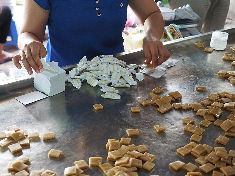 Manufacture of handmade coconut candies in Ben Tre South Vietnam with Man Nguyen Private Vietnam Tour Packages
